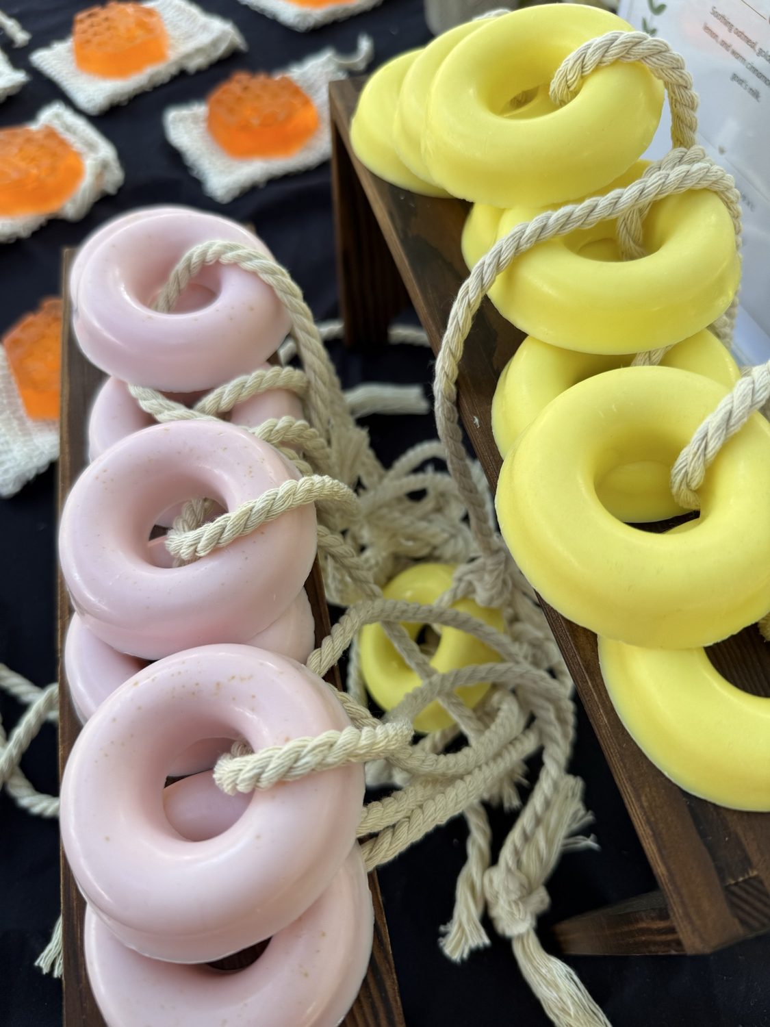 Donut-shaped soap on a rope in pink and yellow