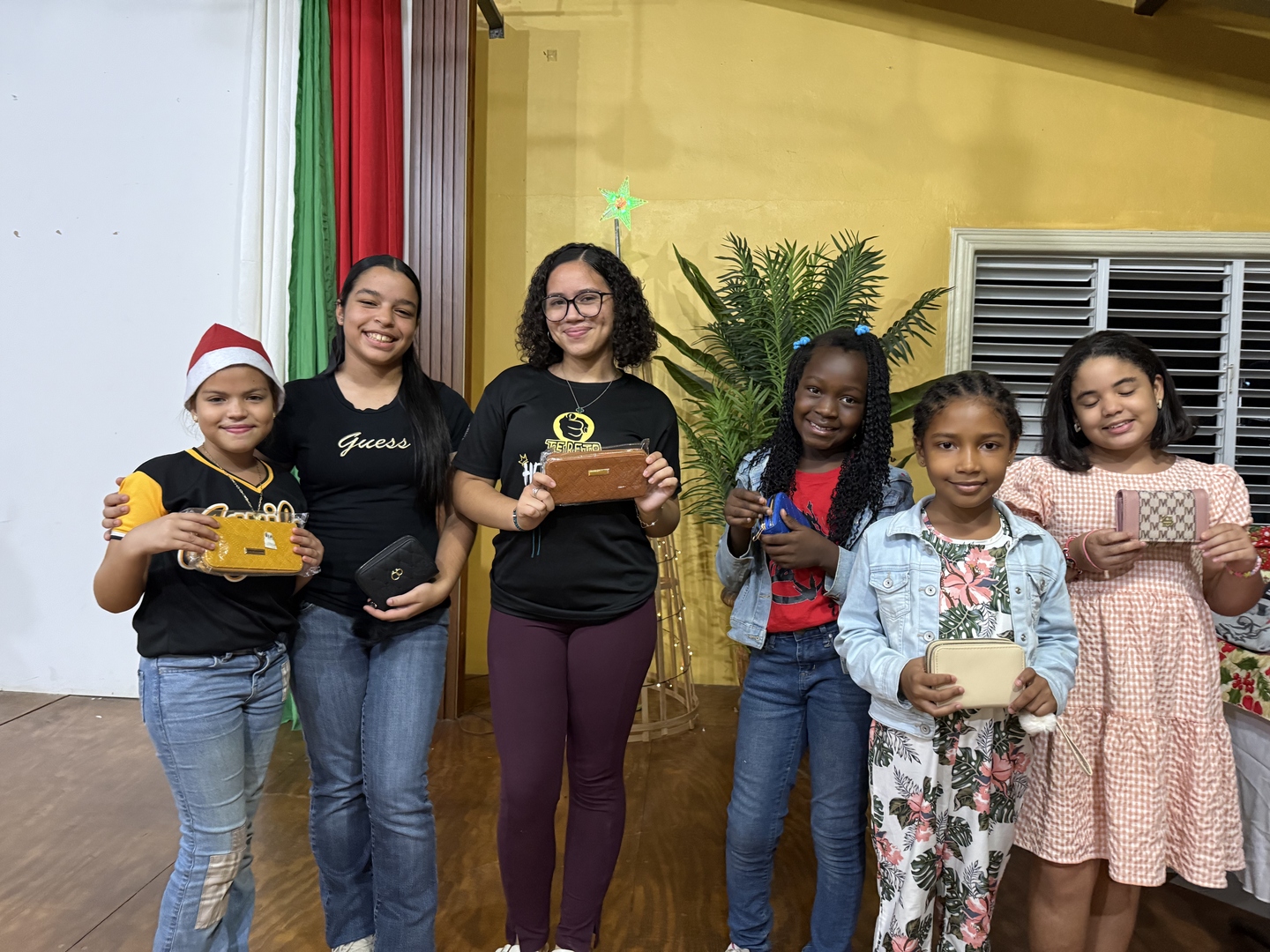Children receiving gifts at a Christmas celebration
