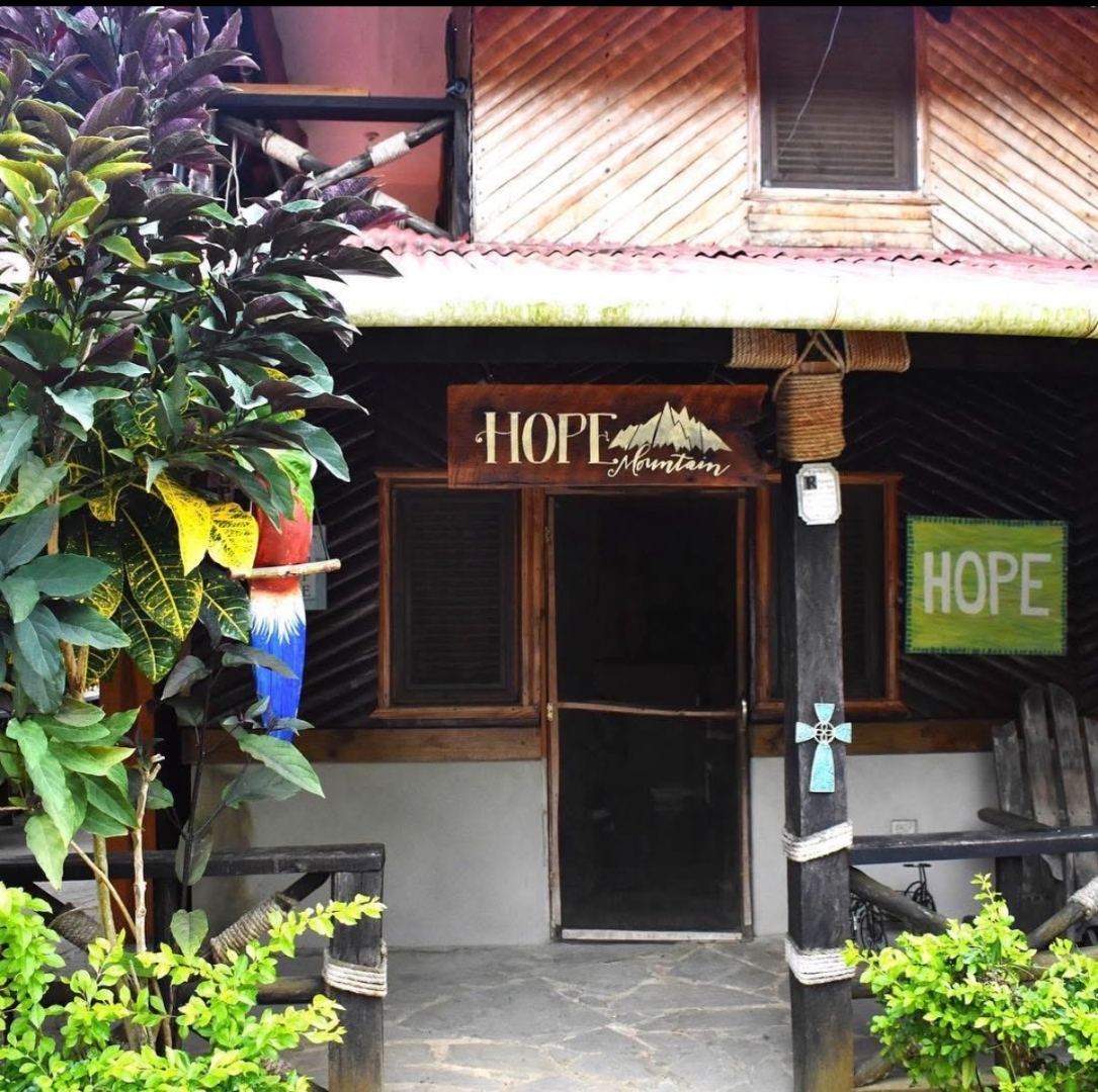 The Hope Mountain cabin entrance with its carved wooden sign