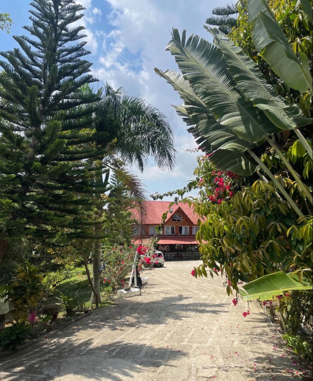Garden path leading up to the red-roofed Hope Mountain retreat house